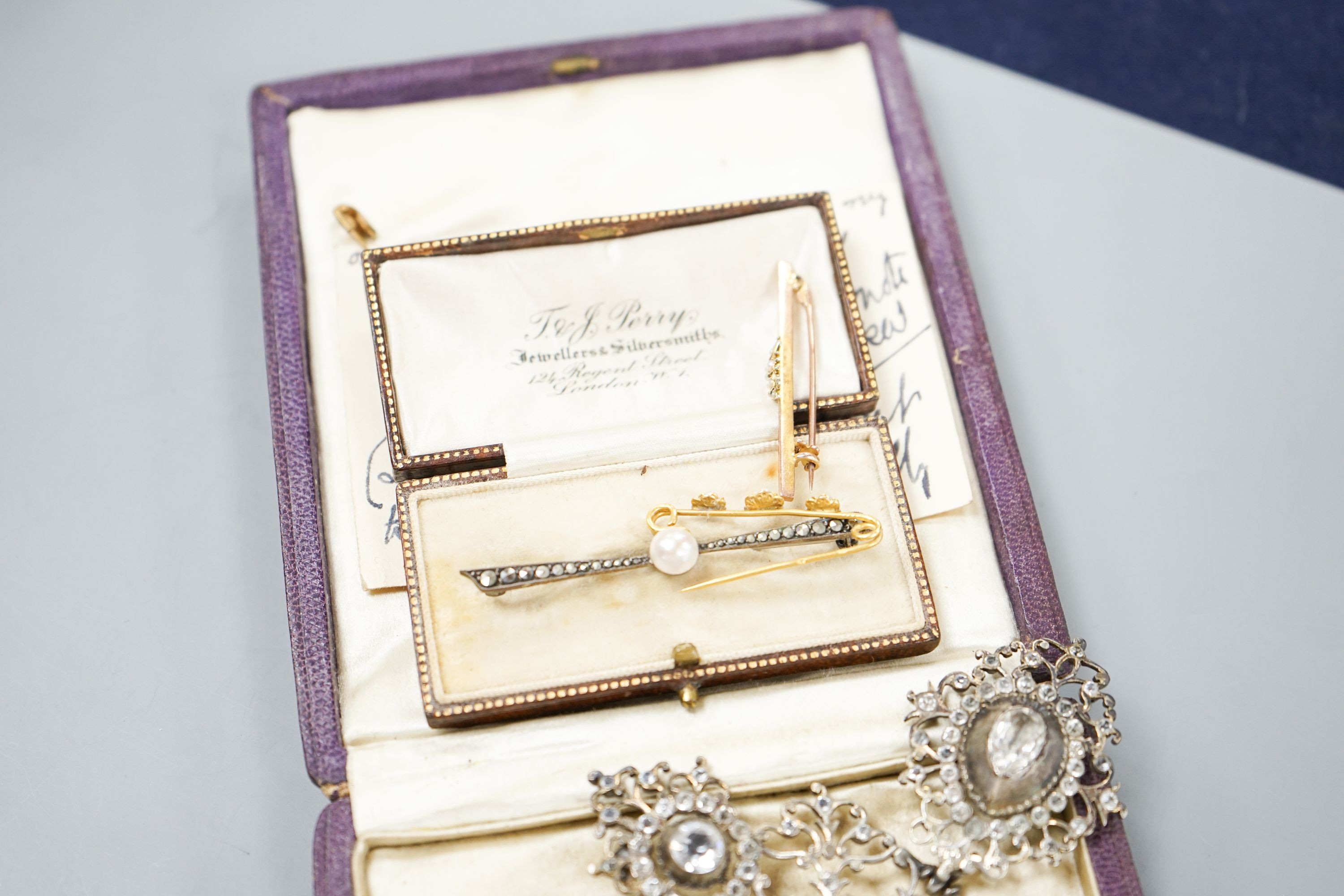 A white metal and paste set drop pendant, 10.7cm, a modern silver gilt bangle, a 9ct gold bar brooch, two other brooches and a marcasite set lorgnettes.